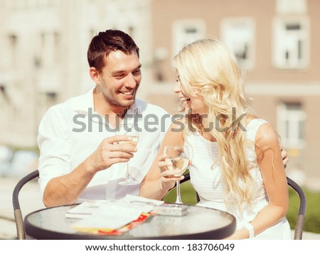 summer holidays and dating concept couple drinking wine in cafe in the city summer holidays and dating concept couple drinking wine in cafe in the city