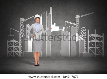 building, developing, advertising and architecture concept - smiling businesswoman in white helmet showing scketch of construction site