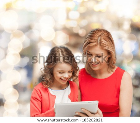 family, child and technology concept - smiling mother and daughter with tablet pc computer