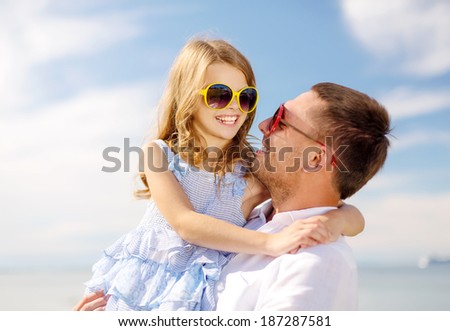 summer holidays, family, children and people concept - happy father and child girl having fun outdoors