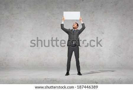 business, education, office and advertising concept - smiling businessman with small white blank board