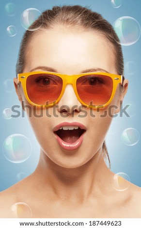 summer holidays, beauty, happiness and people concept - teenage girl in shades with expression of surprise