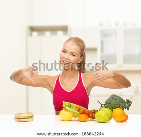 fitness, healthcare and diet concept - smiling woman with fruits and hamburger showing good and bad signs