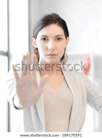 business concept - young woman making stop gesture