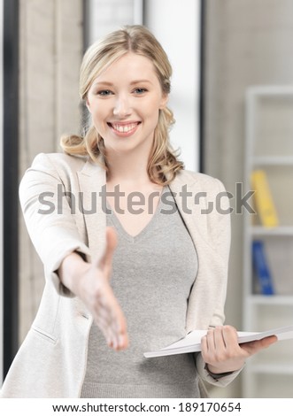 business concept - lovely woman with an open hand ready for handshake