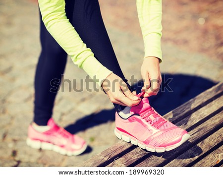 sport fitness exercise and lifestyle concept runner woman lacing trainers shoes sport fitness exercise and lifestyle concept runner woman lacing trainers shoes