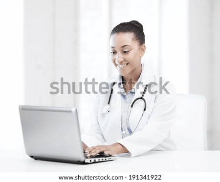 healthcare, medical and technology concept - african female doctor with laptop pc