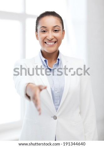 business and education concept - african businesswoman with an open hand ready for handshake