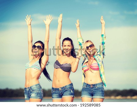 summer, holidays, vacation, happy people concept - beautiful teenage girls or young women having fun on the beach