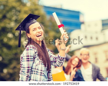 education, campus and teenage concept - smiling teenage girl in corner-cap with diploma and classmates on the back
