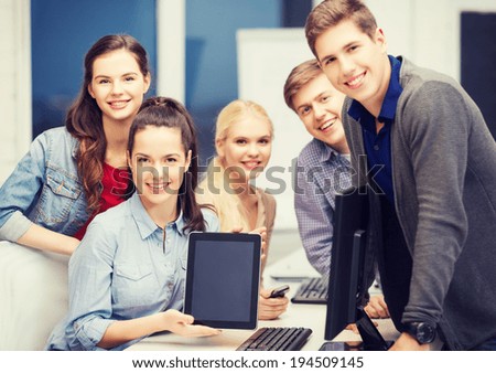 education, technology and internet concept - students with monitor and blank tablet pc screen