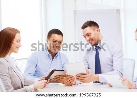 business and office concept - smiling business team working with tablet pc computers in office