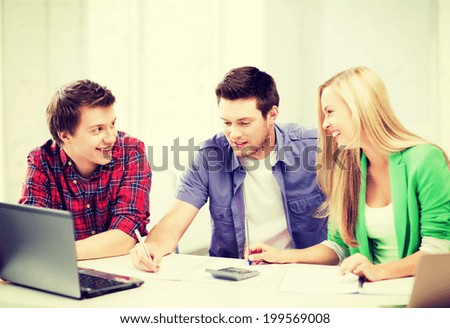 education concept - smiling students chatting in lecture at school