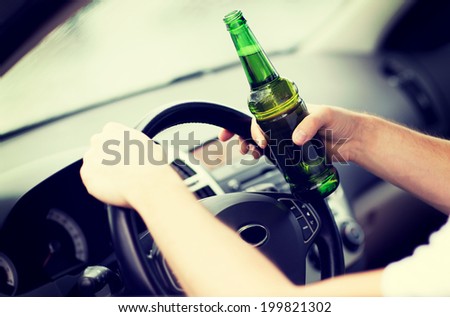transportation and vehicle concept - man drinking alcohol while driving the car