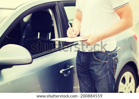 transportation and ownership concept - man with car documents