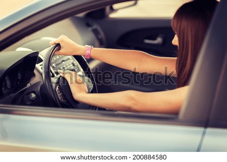 transportation and vehicle concept - woman driving a car with hand on horn button