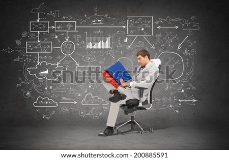 business and office concept - handsome businessman in suit with folders sitting on chair