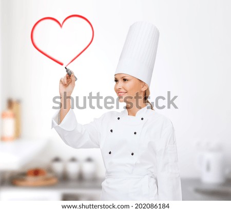 cooking, new technology , advertisement and food concept - smiling female chef with marker writing something on virtual screen