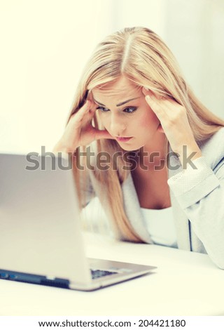 picture of stressed businesswoman with laptop at work