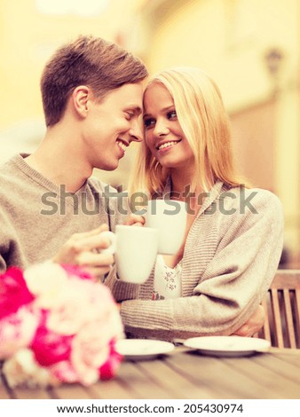 summer holidays, love, travel, tourism, relationship and dating concept - romantic happy couple kissing in the cafe