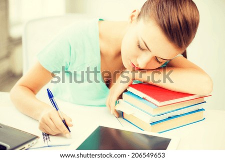 picture of tired student sleeping on stock of books