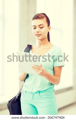 education and technology - smiling student with tablet pc in college