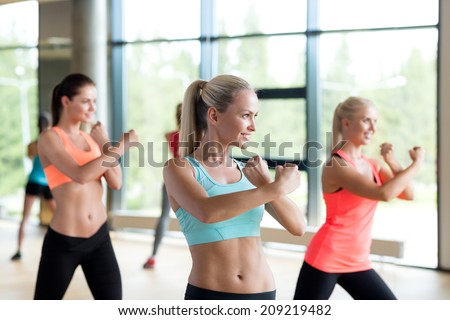 fitness, sport, training, gym and lifestyle concept - group of women working out in gym