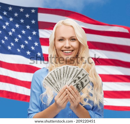 finances and people concept - smiling woman in red dress with us dollar money over american flag background