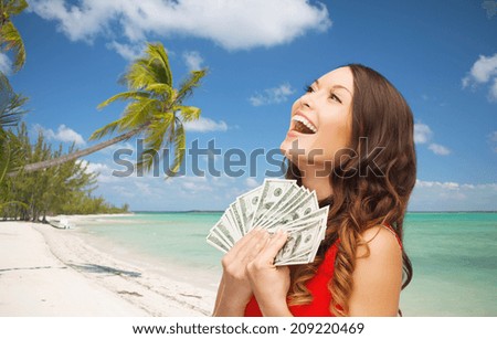 christmas, x-mas, sale, banking and travel concept - smiling woman in red dress with us dollar money over tropical beach background