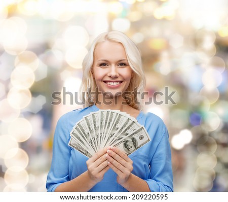 finances and people concept - smiling woman in red dress with us dollar money