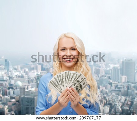 finances and people concept - smiling woman in red dress with us dollar money over cityscape background