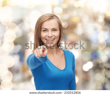 gesture and people concept - smiling student pointing finger at you