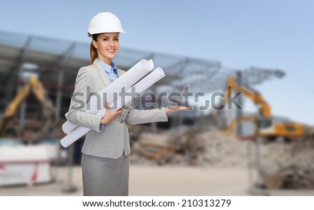 building, developing, construction and architecture concept - smiling woman in white helmet with blueprint