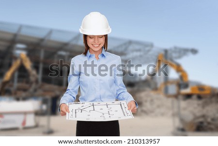 building, developing, construction and architecture concept - smiling businesswoman in white helmet looking at blueprint