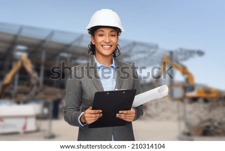building, developing, construction and architecture concept - smiling woman in white helmet with blueprint and clipboard