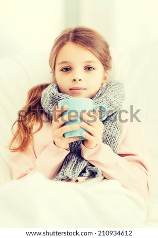 healthcare and medicine concept - ill girl child with cup of hot tea