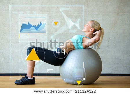 fitness, sport, training, future technology and lifestyle concept - smiling woman with exercise ball in gym over graph projection