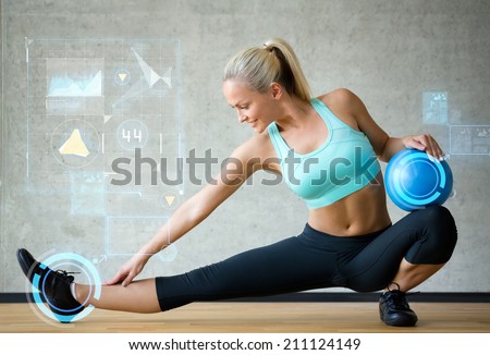 fitness, sport, training, future technology and lifestyle concept - smiling woman with exercise ball in gym over graph projection