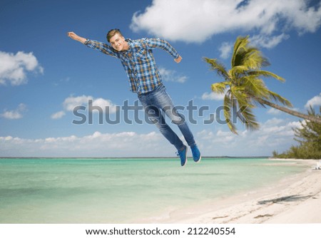happiness, freedom, movement and people concept - smiling young man flying in air