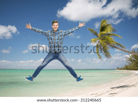 summer vacation, travel, tourism, freedom and people concept - smiling young man jumping in air over tropical beach background