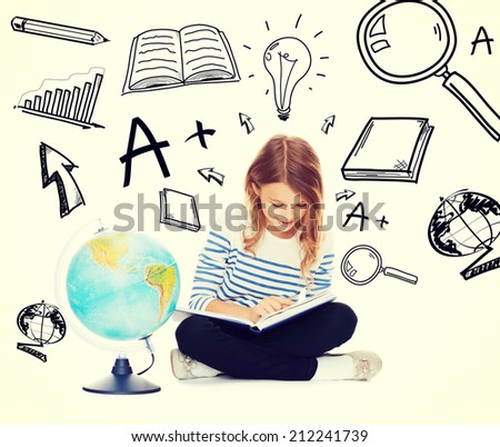 education and school concept - little student girl studying geography with globe and book