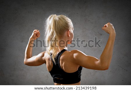 Woman flexing her biceps - Stock Image - Everypixel