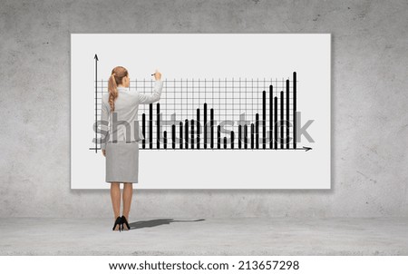 business, development and office people concept - businesswoman with marker drawing chart over concrete wall background from back