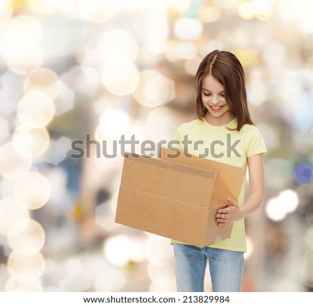 advertising, childhood, delivery, mail and people - smiling girl holding open cardboard box and looking into it over holidays background