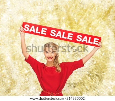 sale, shopping, christmas, holidays and people concept - smiling woman in red dress with red sale sign over yellow lights background
