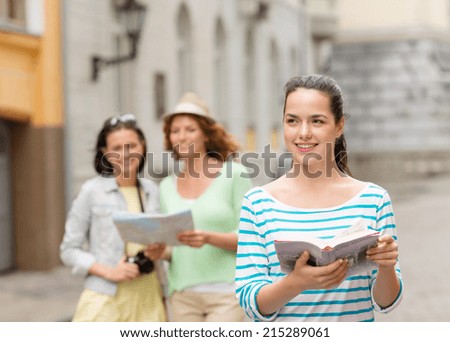tourism, travel, leisure and holidays concept - smiling teenage girls with city guide, map and camera outdoors