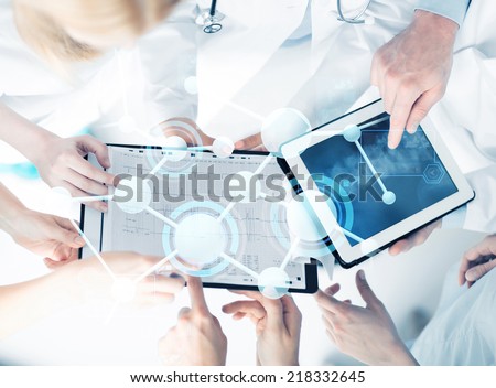 healthcare, technology, medicine and people concept - group of doctors with tablet pc, clipboard and molecular projection