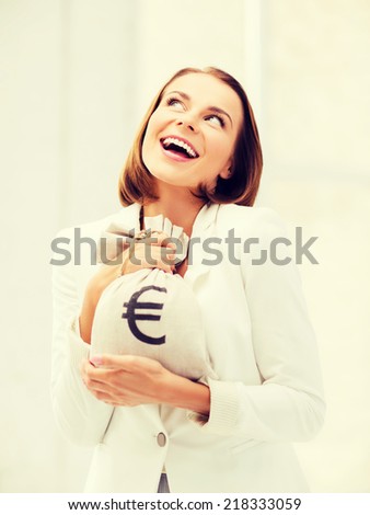 business and money concept - young businesswoman holding money bag with euro