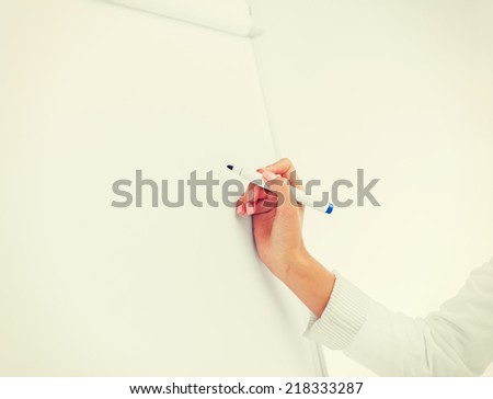 business, office, school and education concept - businesswoman working with flip board in office