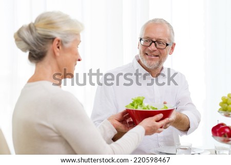 family, holidays, thanksgiving, christmas and people concept - smiling senior couple having dinner at home